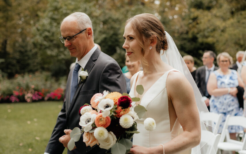 Temple's Country Weddings bride walking down the isle during a garden ceremony