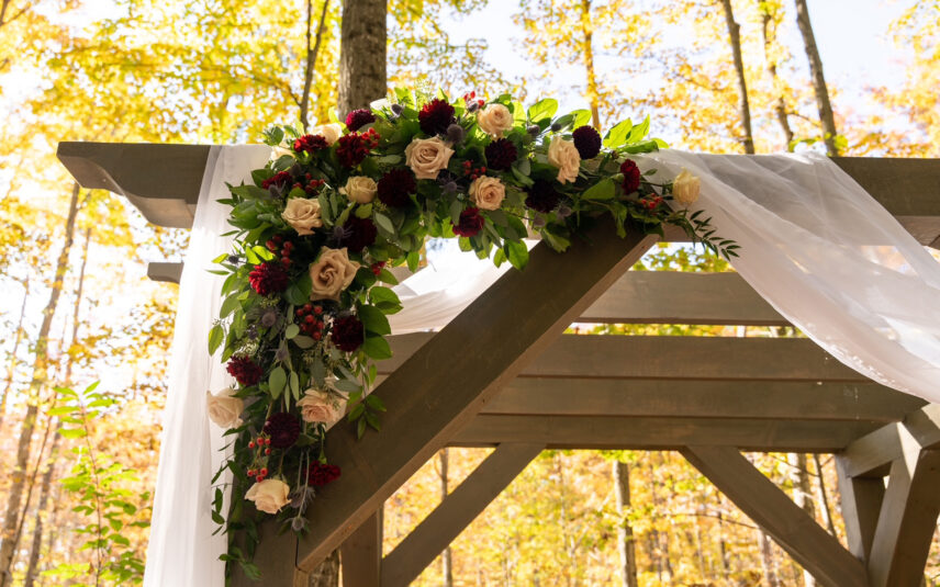Temple's Country Weddings forest ceremony archway with florals